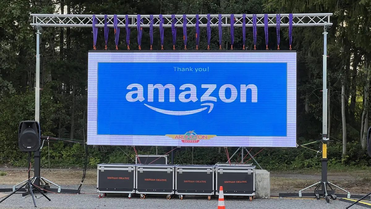 A sponsor thank-you slide for Amazon on a City Park Events video wall in Arlington